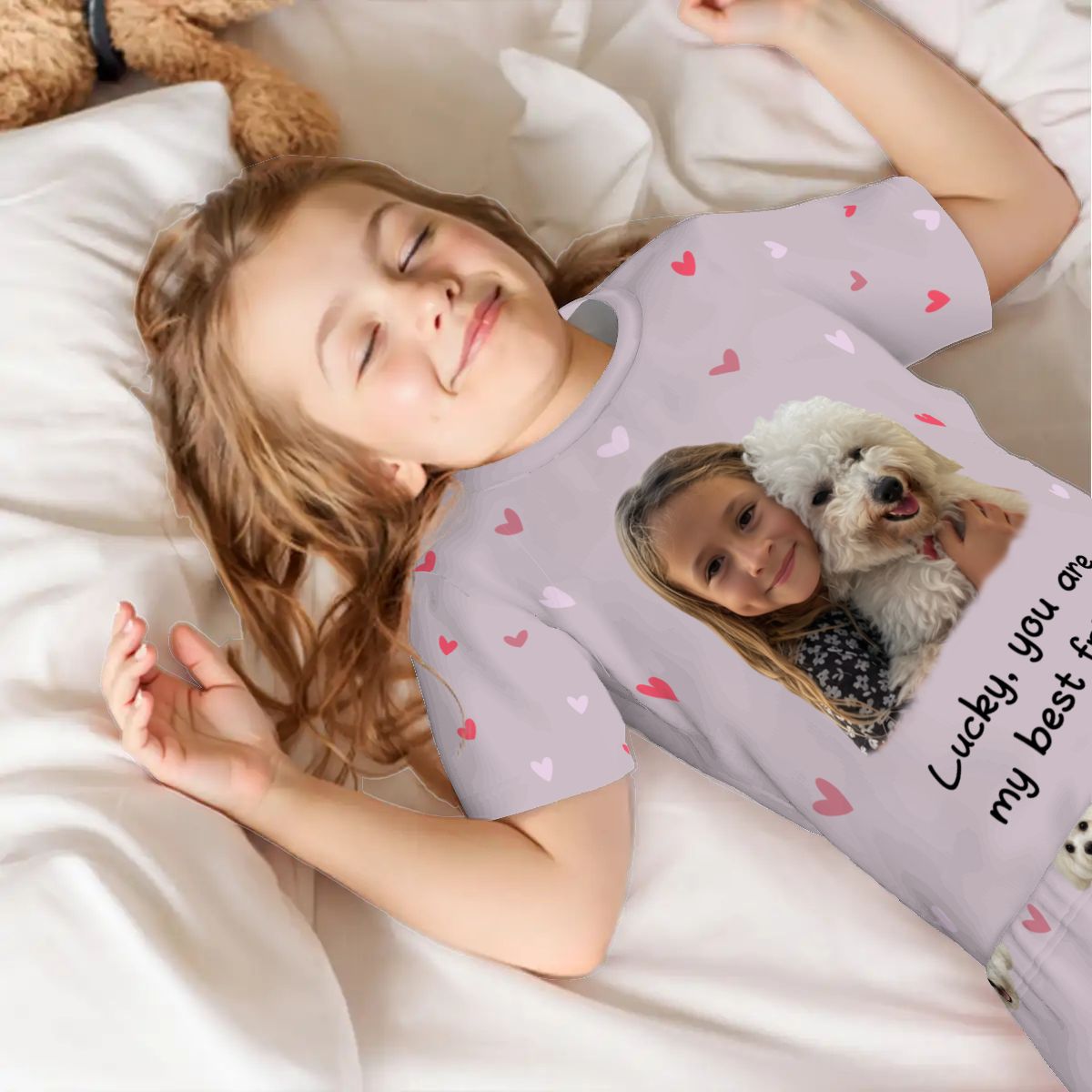 A child wearing a bespoke pet art pajama set while sleeping. A heartwarming example of how we bring meaningful scenes to life on high-quality apparel for your non-human family.