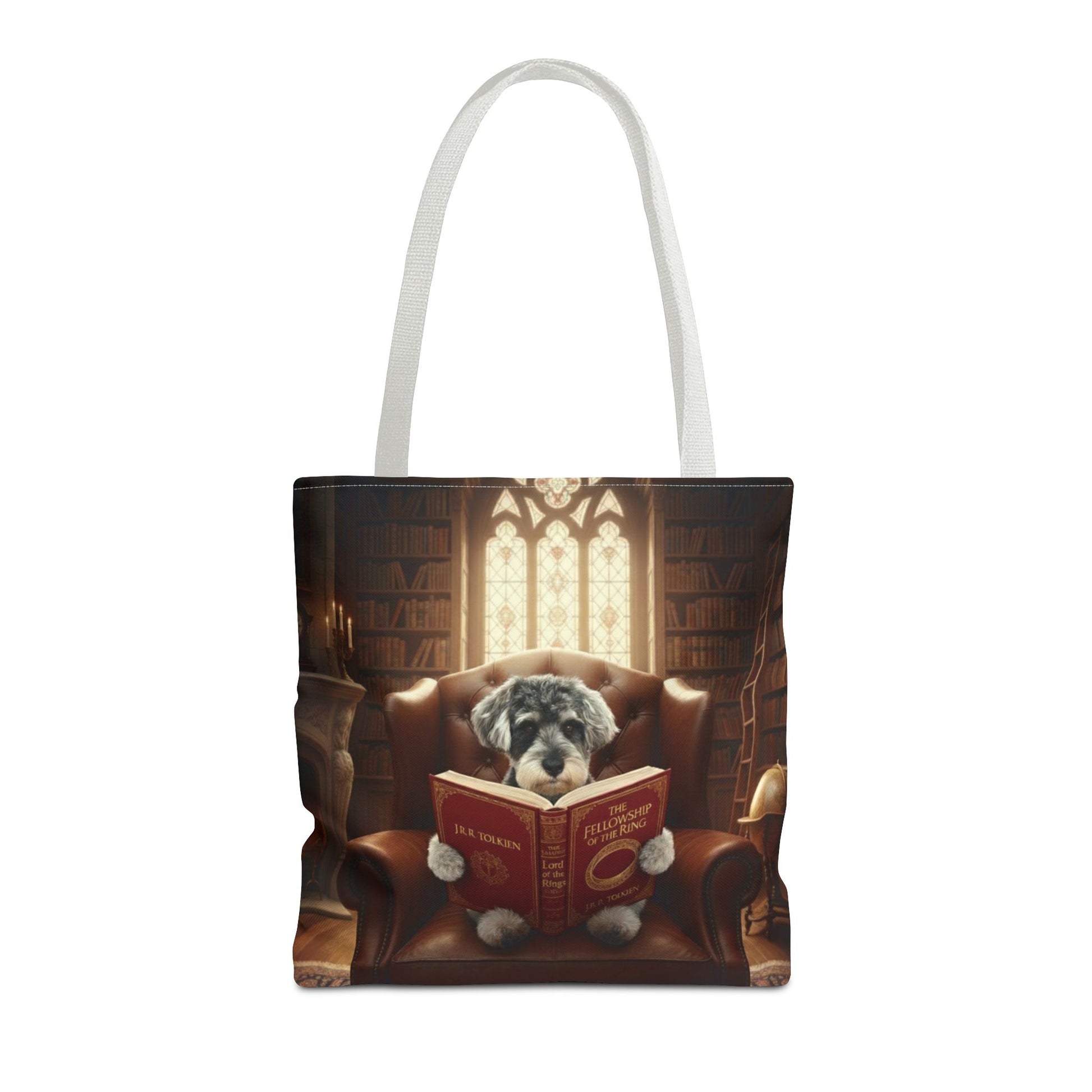All-over print tote bag with white handle, shown in 16"x16". Featuring an example bespoke scene of a dog reading a book, in an old library. We design unique art for you and your non-human family.