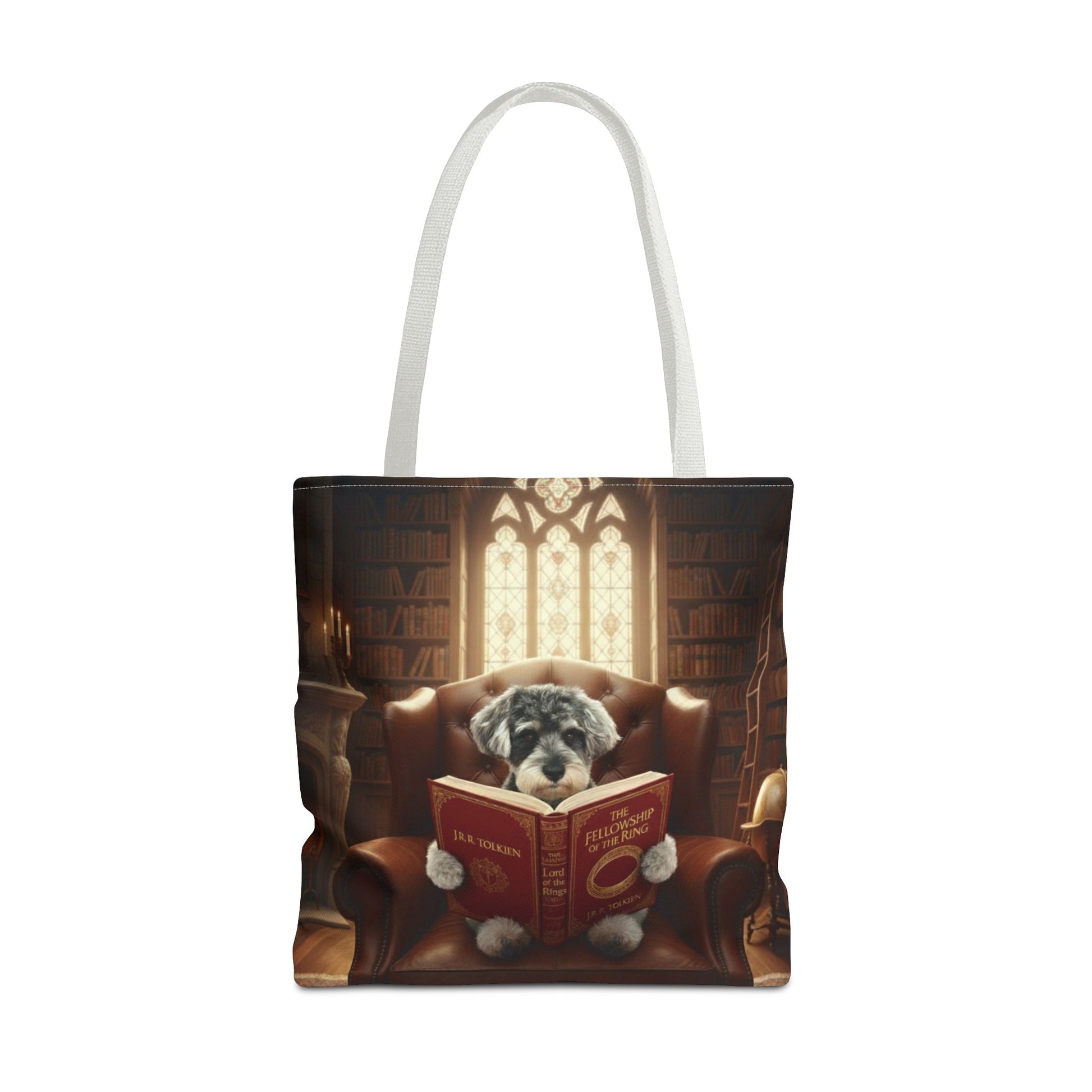 All-over print tote bag with white handle, shown in 18"x18". Featuring an example bespoke scene of a dog reading a book, in an old library. We design unique art for you and your non-human family.