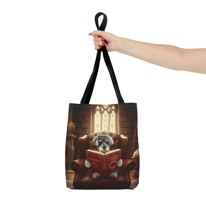 Proud parent holding a bespoke all-over print tote bag. Example design featuring a dog reading in a library; we transform your pet photos into meaningful scenes.