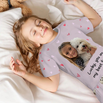 A child wearing a bespoke pet art pajama set while sleeping. A heartwarming example of how we bring meaningful scenes to life on high-quality apparel for your non-human family.