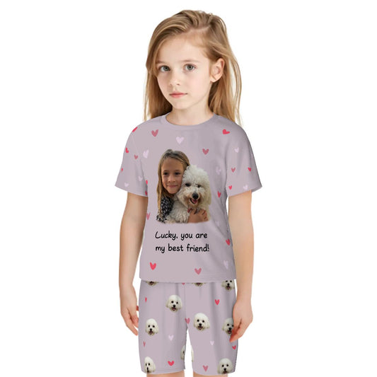 Bespoke kids pajama set with an all-over print featuring an example scene of a child and their dog, saying "Lucky [which is the dog's name], you are my best friend!" We transform your photos into a unique, custom-colored design for the proud parent.