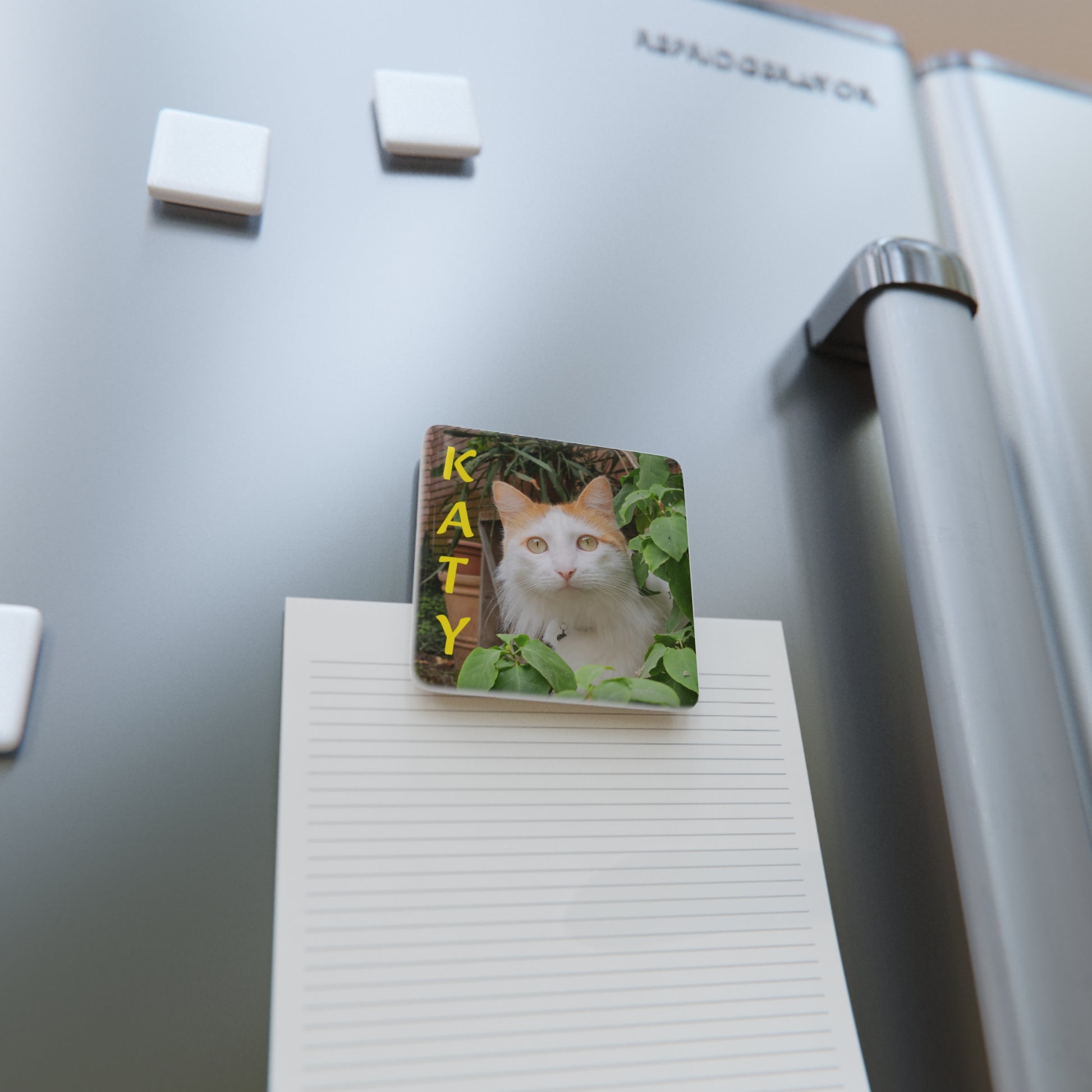 Bespoke pet magnet holding a note on a refrigerator door. Every design is a unique example created to honor the bond with your cherished non-human family.